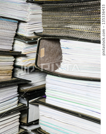 Stacks of accounting document folders with paperwork in office archive and financial records storage Stacks of accounting document folders with paperwork in office archive and financial records storage 135336433
