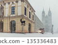 Historic Altermarkt square Magdeburg at heavy snowfall show Rathaus architecture, statues lanterns empty urban space winter storm. Municipal service tractor cleaning snow with snow plow 135336483