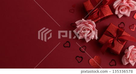 Festive Red Gift Boxes with Roses and Heart Confetti on Red Festive Background for Valentine's Day Celebration Festive Red Gift Boxes with Roses and Heart Confetti on Red Festive Background for Valentine's Day Celebration 135336578