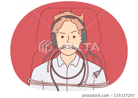 Man is tied up with computer wires and shows aggressive grimace caused by professional burnout Man is tied up with computer wires and shows aggressive grimace caused by professional burnout 135337297