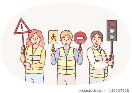 Traffic controllers urge young children to be careful while driving, holding road signs in hands Traffic controllers urge young children to be careful while driving, holding road signs in hands 135337306