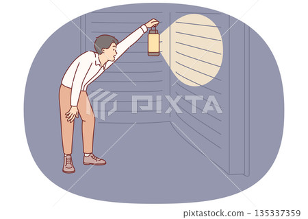 Man reads giant book with interest, holding lantern to illuminate encyclopedia at night 135337359