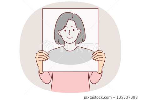 Anonymous woman hides face behind banner with fake portrait to remain incognito and leave no traces 135337398