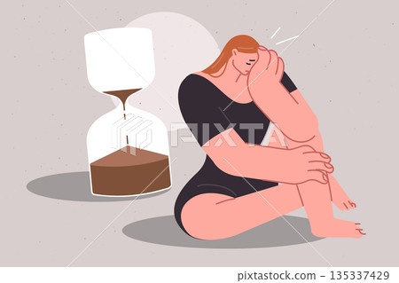 Tight deadlines negatively affect psychological state of girl crying, sitting near large hourglass 135337429