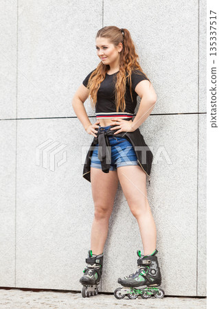Young woman riding roller skates Young woman riding roller skates 135337517