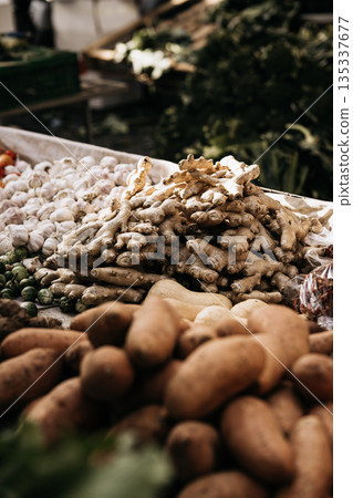 Fresh Seasonal Vegetables At Traditional Market Stall: Artichokes, Beans, Cabbage, Zuccini, Potatoes, And Root Vegetables Displayed In Abundant Mediterranean Food Market Scene Fresh Seasonal Vegetables At Traditional Market Stall: Artichokes, Beans, Cabbage, Zuccini, Potatoes, And Root Vegetables Displayed In Abundant Mediterranean Food Market Scene 135337677