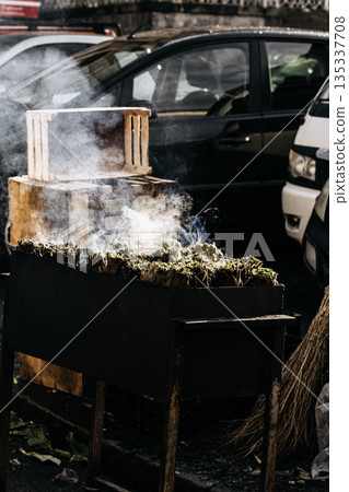 Fresh Artichokes Barbecue At Catania Market In Sicily: Trimming And Steaming Green Vegetables On Hot Surface In Traditional Street Food Scene Fresh Artichokes Barbecue At Catania Market In Sicily: Trimming And Steaming Green Vegetables On Hot Surface In Traditional Street Food Scene 135337708