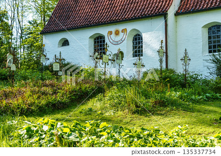 Church St.Clemens in Kranzberg near Freising, Bavaria with ancient graveyard and beautiful old wrought iron crosses Church St.Clemens in Kranzberg near Freising, Bavaria with ancient graveyard and beautiful old wrought iron crosses 135337734