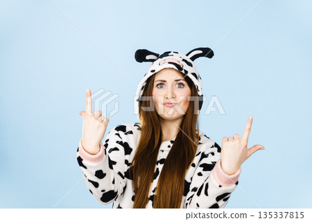 Woman wearing pajamas cartoon pointing up Woman wearing pajamas cartoon pointing up 135337815