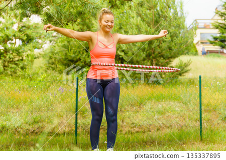 Young woman with hoola hoop outdoors 135337895