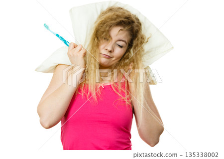Sleepy woman hugging white pillow Sleepy woman hugging white pillow 135338002