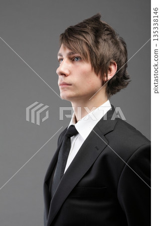 young businessman black suit casual tie on gray background 135338146