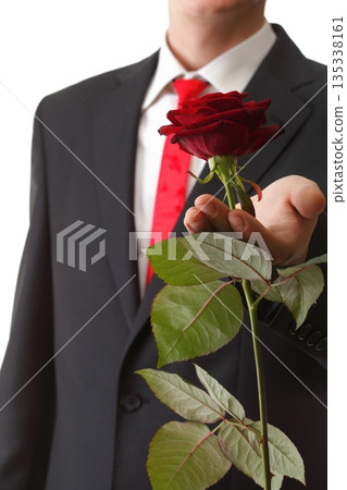 Young man presenting a flower red rose isolated 135338161