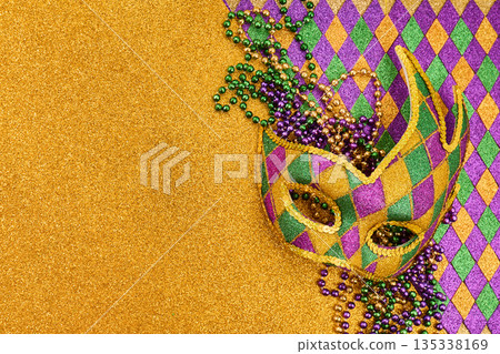 Mardi gras mask and beads on glitter background Mardi gras mask and beads on glitter background 135338169