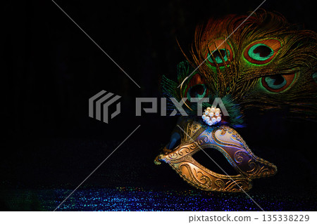 Venetian masquerade mask with peacock feathers 135338229