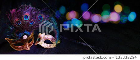 Venetian carnival masks with peacock feathers and bokeh lights 135338254