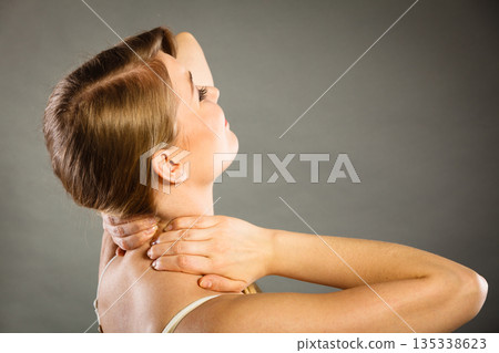 Woman suffering from neck pain Woman suffering from neck pain 135338623