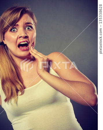 Woman suffering from tooth pain 135338628