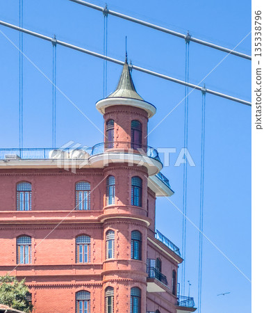Borusan Contemporary's historic brick building showcases unique architectural details under clear blue skies. 135338796