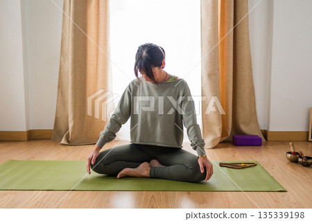 Hispanic woman warming up for yoga class Hispanic woman warming up for yoga class 135339198
