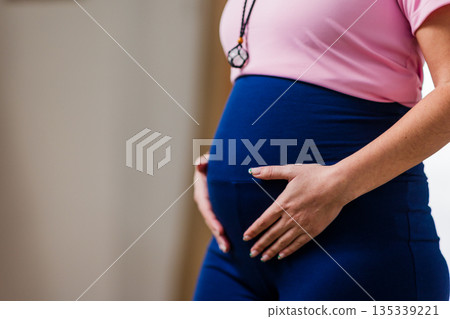 Pregnant woman exercising, embracing health and wellness Pregnant woman exercising, embracing health and wellness 135339221