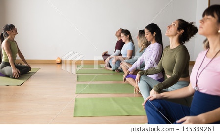 Diverse group of women practicing prenatal yoga meditation Diverse group of women practicing prenatal yoga meditation 135339261