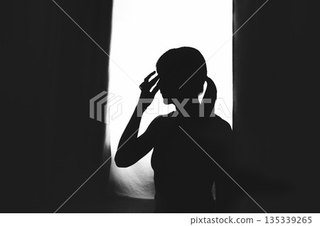 Hispanic woman silhouette preparing for mindful vinyasa yoga Hispanic woman silhouette preparing for mindful vinyasa yoga 135339265