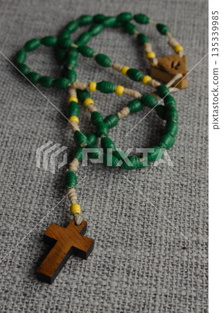 Rosary beads with a wooden cross, symbolizing Christian prayer, devotion and tradition 135339985