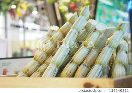 Sugar cane stacked in a wooden crate at a market Sugar cane stacked in a wooden crate at a market 135340811