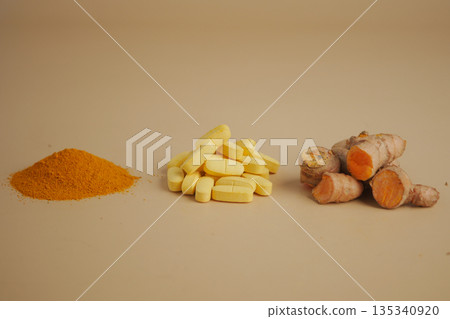 Turmeric in different forms on a plain background 135340920