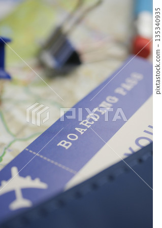 Planning for a trip with a boarding pass in focus Planning for a trip with a boarding pass in focus 135340935