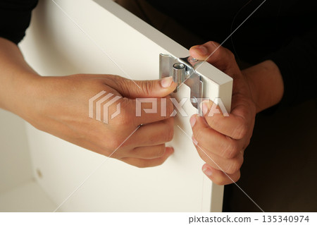 Assembling furniture in a workshop during daytime hours 135340974