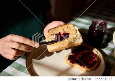 Cozy Breakfast Toast With Peanut Butter And Jam On Checkered Tablecloth 135341072