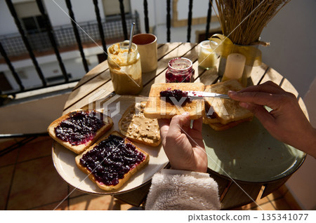 Sunny Balcony Breakfast With Peanut Butter And Jelly Toasts On A Round Table 135341077