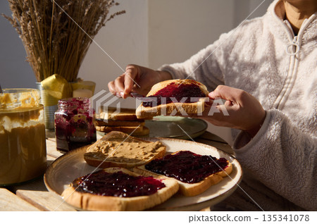 Cozy Breakfast Scene With Jam On Toast And Peanut Butter For Peanut Butter And Jelly Day Cozy Breakfast Scene With Jam On Toast And Peanut Butter For Peanut Butter And Jelly Day 135341078