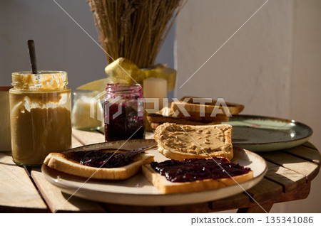 Cozy Breakfast Scene With Peanut Butter And Jelly Toasts On A Wooden Table 135341086