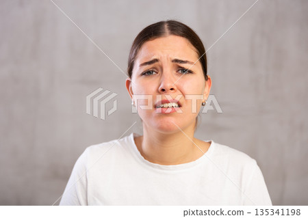 Portrait of sad young woman in t-shirt Portrait of sad young woman in t-shirt 135341198