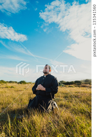 Monk On His Knees Feeling The Christianity  135341560
