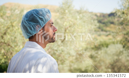 Agronomy expert taking a look at olive trees in the countryside Agronomy expert taking a look at olive trees in the countryside 135341572