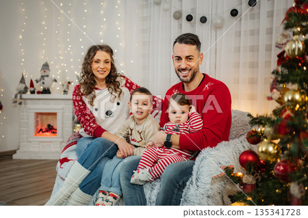 Family celebrating Christmas at decorated home together Family celebrating Christmas at decorated home together 135341728