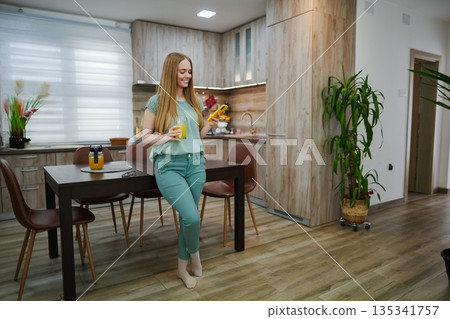 Joyful morning in a cozy kitchen with fresh juice and vibrant plants Joyful morning in a cozy kitchen with fresh juice and vibrant plants 135341757