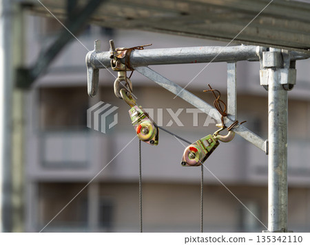 Pulley attached to scaffolding at a construction site Pulley attached to scaffolding at a construction site 135342110