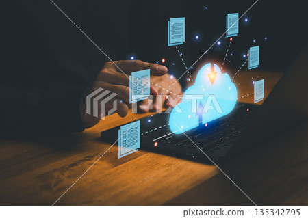 Cloud computing and data storage concept showing a person using a laptop with cloud icon, upload and download, representing online data backup, digital storage, and secure information sharing. Cloud computing and data storage concept showing a person using a laptop with cloud icon, upload and download, representing online data backup, digital storage, and secure information sharing. 135342795