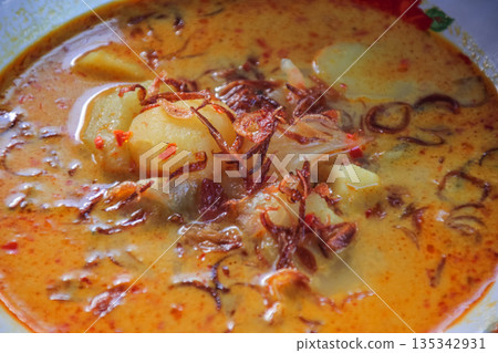 Authentic Lombok Cuisine: Begawe Dish with Spices and Coconut Milk, Featuring Tender Potatoes and Crispy Fried Onions - A Culinary Delight Authentic Lombok Cuisine: Begawe Dish with Spices and Coconut Milk, Featuring Tender Potatoes and Crispy Fried Onions - A Culinary Delight 135342931