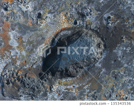 Aerial view of a geothermal area in Iceland with a bubbling mud pot, volcanic rock, and orange and yellow mineral deposits in a textured landscape. Aerial view of a geothermal area in Iceland with a bubbling mud pot, volcanic rock, and orange and yellow mineral deposits in a textured landscape. 135343536