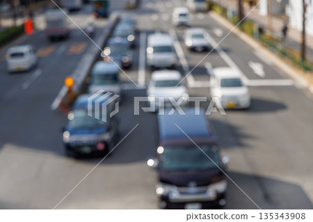 Abstract bokeh background of cars driving on urban road and cityscape (out of focus) 135343908