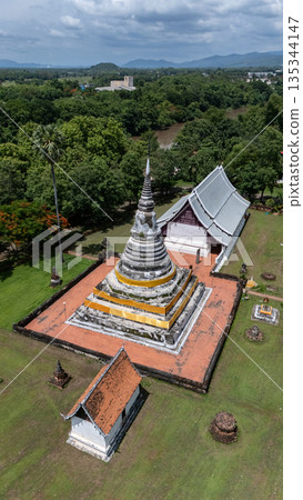 Aerial view of sacred pagoda enshrined the Buddha's relics in Wat Phra Fang temple in Uttaradit province of Thailand. Built since 1700 B.E. during Sukhothai period. Aerial view of sacred pagoda enshrined the Buddha's relics in Wat Phra Fang temple in Uttaradit province of Thailand. Built since 1700 B.E. during Sukhothai period. 135344147