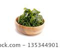Seaweed wakame in wood bowl on white background. 135344901