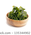 Seaweed wakame in wood bowl on white background. 135344902