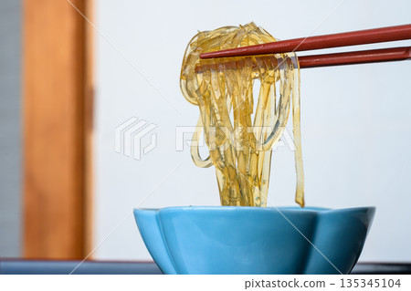 Transparent tokoroten noodles picked up with chopsticks - a specialty of Izu, Amakusa cuisine Transparent tokoroten noodles picked up with chopsticks - a specialty of Izu, Amakusa cuisine 135345104